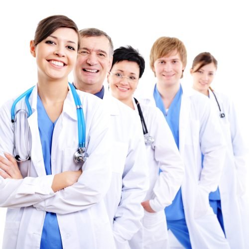 happy laughing female doctors in hospital gowns in row